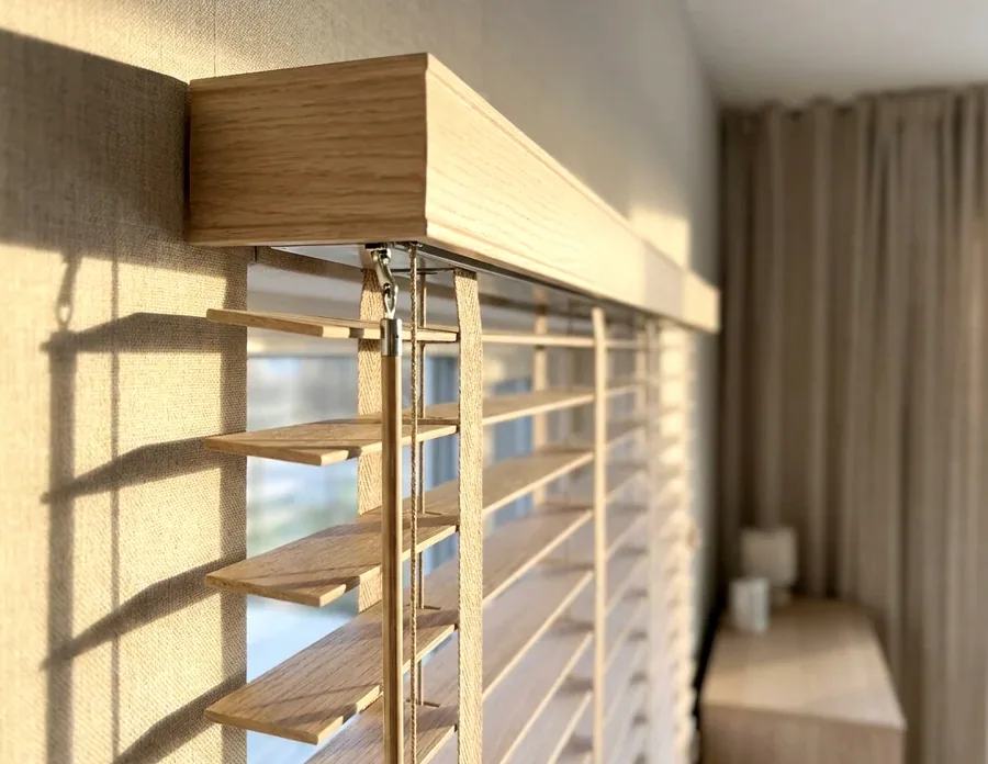 Timber venetian headrail, cords and tilt mechanism up close — the parts we repair and restring in Birdhaven, Johannesburg