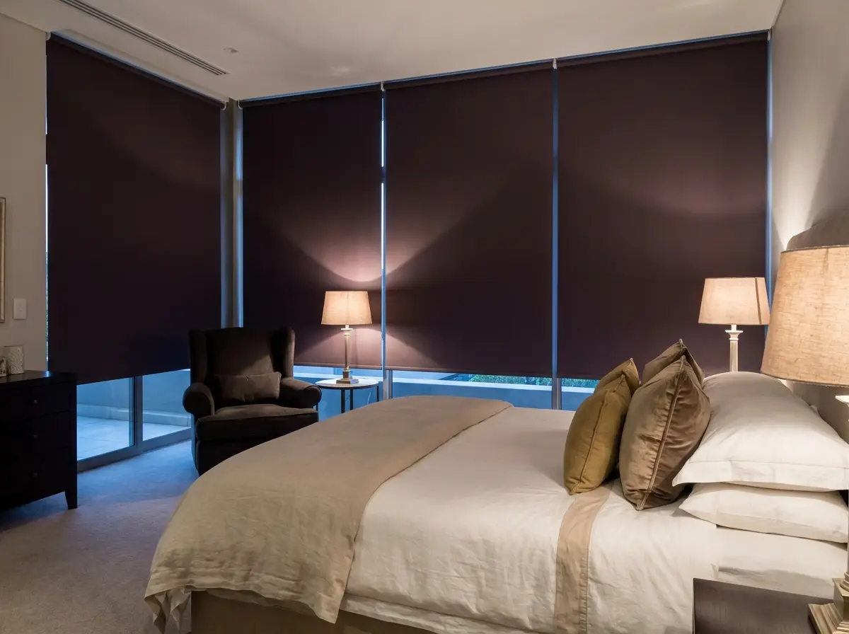 Bedroom in a Birdhaven home fitted with blockout blinds in aubergine-brown and old gold tones